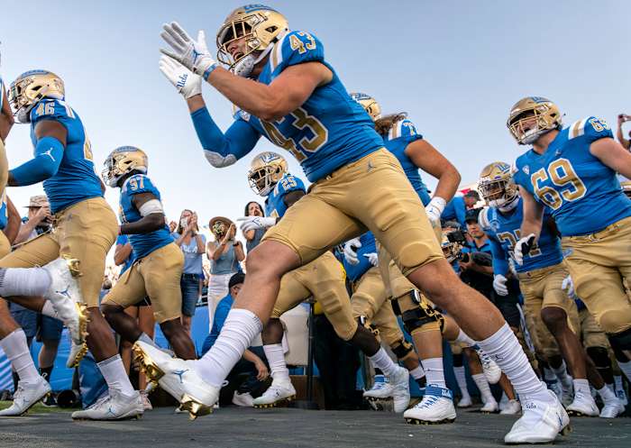 UCLA players take the field at the Rose Bowl before upsetting LSU.